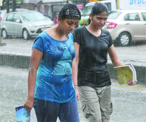 Girls caught in the pre-monsoon rain that greeted Delhiites on Monday morning.