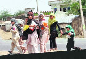 Girl students cross the road in Mewat