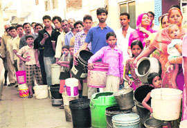 Residents stand in a queue for water at Santokhpura in Jalandhar. 