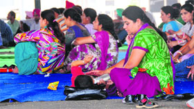 A child being fed while her mother protest against the Punjab government at Dana Mandi in Ludhiana. 