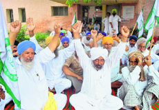 Farmers stage a dharna outside the 66-KV grid at Pasiana villlage in Patiala on Monday. 