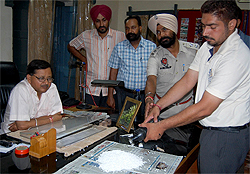 Jail officials show the habit-forming drugs seized from near the boundary walls of the Central Jail