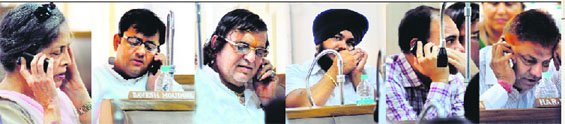 Despite a ban on using mobile phones during municipal corporation House meetings, councillors (from left) Amrita Tiwari (nominated), Davesh Moudgil (BJP), Gurcharan Dass Kala (independent), Malkit Singh (SAD), Mukesh Bassi (Congress) and Rajesh Gupta (BJP) use mobile phones during the meeting at Sector 17 in Chandigarh on Tuesday.
