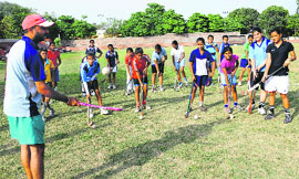 Hockey players hone skills under the supervision of Alpinder Singh during a practice session at the Hockey Stadium in Sector 18, Chandigarh, on Tuesday.