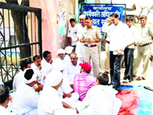 Sarpanches of Kharkhoda block villages stage a dharna after locking the main entrance to the BDPOs office at Kharkhoda on Tuesday. 
