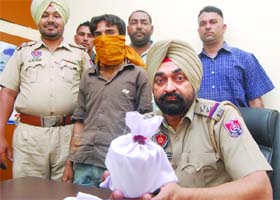 Ravi Kumar (in covered face) was nabbed with intoxicant powder in Jalandhar on Tuesday
