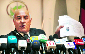 Mohammad Esaaq Aloko, Attorney General of Afghanistan, shows the picture of a suspected insurgent of the Taliban during a news conference in Kabul on Tuesday.