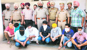 Members of a gang of fake travel agents in the police custody in Amritsar on Wednesday. 