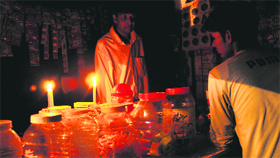 A shopkeeper lights up a candle at his shop in Sector 42, Chandigarh, on Wednesday.