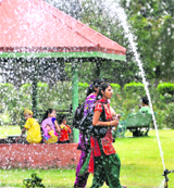 Girls walk past a fountain at Phase IIIB2 in Mohali.