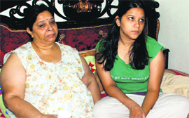 Terror struck Vaishali sits in company of her mother Prabha Thakur at their house in Sector 10, Panchkula, on Wednesday.