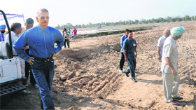 UT Administrator Shivraj V Patil, along with officials of various departments of the UT Administration, surveys the dried up patch of Sukhna Lake in Chandigarh on Wednesday.