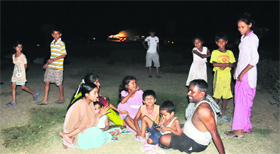 Residents of Sectors 42 and 43 sit on the Sectors 35, 36, 42 and 43 roundabout to escape the sweltering heat.