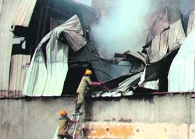 Firemen struggle to douse the flames in an auto parts company in Sector 37 of Gurgaon on Wednesday