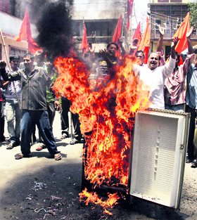 Activists of the Shiv Sena and the Dogra Front burn a refrigerator and raise slogans during a protest against the electricity shortage in Jammu on Wednesday.
