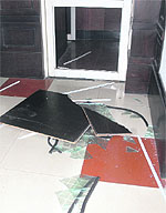 Agitators break a door pane at the MC office in Jalandhar on Wednesday