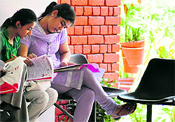 Students fill admission forms in a city college