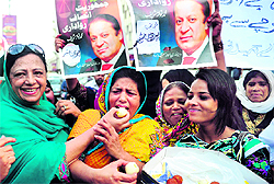 Pakistan Muslim League (Nawaz) supporters celebrate the verdict against Prime Minister Yousuf Raza Gilani in Karachi on Wednesday