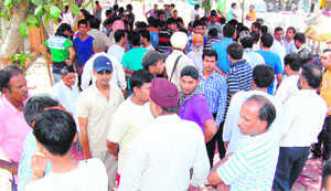 Residents gathered outside the house of the victim in Amritsar on Thursday. 