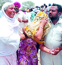 Relatives (above and below) of the victims of the car-train accident grieve uncontrollably