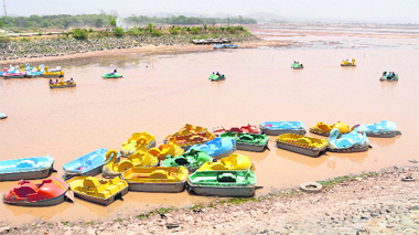 Four-seater boats lie grounded at the Sukhna Lake in Chandigarh on Thursday. 