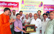 Rajya Sabha member Ram Prakash (fifth from right) honours Dr Sameer Kaushal (fourth from left) of Amar Hospital, Mohali, in Kurukshetra. 