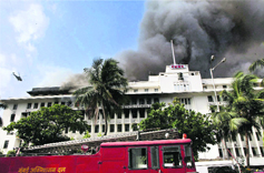 A helicopter surveys the Maharashtra Mantralaya engulfed in a major fire in Mumbai on Thursday. Several persons, who remained trapped on the upper floors and terrace, were hospitalised. The authorities pressed into service elite commandos to rescue those trapped.  PTI