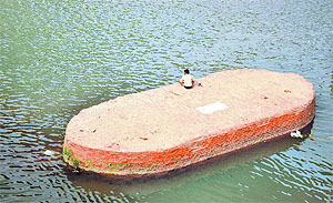 A man finds an isolated spot to enjoy the cool envrions of the Tawi in Jammu on Thursday