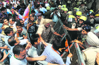 BJP activists protest the hike in petrol prices at the Sector 7 and 8 roundabout in Chandigarh on Friday. Tribune photo: S Chandan