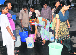 Residents line-up to fill buckets from a water tanker in Chandigarh on Friday. Tribune photo: Vicky Gharu