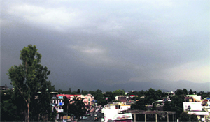 Dark clouds hover over Dehradun giving a respite from the scorching heat on Friday. Tribune photo: Vinod Pundir