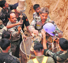 Army, district administration and health officials carry out a rescue operation to save Maahi (4), stuck in a borewell, at Khoh village near Manesar in Gurgaon, on Friday.
