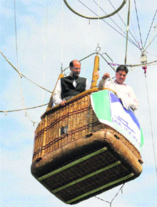 Jammu and Kashmir Minister of State for Home and Tourism Nasir Aslam Wani enjoys a flight in a balloon after launching aero ballooning on the banks of Dal Lake in Srinagar on Friday evening. The minister said the cable-controlled aero balloon facility, the first of its kind in the country, will draw more tourists to Zabarwan Park near the Dal Lake.