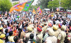 Supporters of the BJP gather outside the District Administrative Complex to court their arrest.