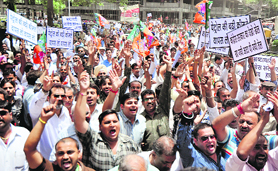 Protest against hike in prices of essential commodities and fuel in Ludhiana on Friday. 