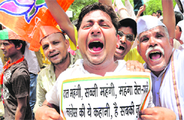 BJP workers protest against price rise in New Delhi on Friday. 