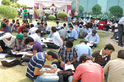 Aspirants filling up forms during a job fair organised at the campus of the Baba Farid Group of Institutions on Saturday. A Tribune Photograph 