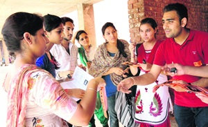 A PUSU member distributes helpline number at Panjab University, Chandigarh. 