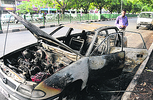 A view of the car that was burnt due to a short-circuit at the road separating Sectors 34 and 35 in Chandigarh on Saturday.