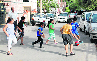 Children play football on a street at Sector 10 in Panchkula.