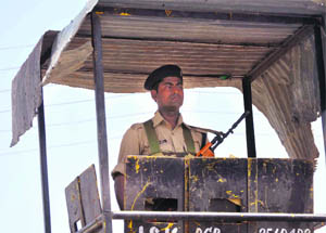 A CRPF jawan stands guard outside the Yatri Niwas, a base camp of Amarnath yatra, in Jammu.  