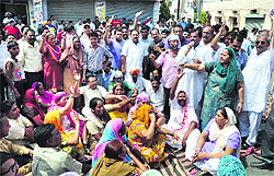 Residents protest against the police on Hambran Road in Ludhiana on Saturday.