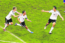 Germanys Philipp Lahm (C) is congratulated by teammates Marco Reus (L) and Miroslav Klose after scoring the opening goal during their match against Greece in Gdansk on Friday. Germany won 4-2. 
