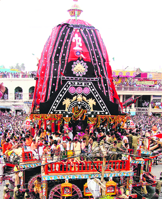 A sea of devotees around colourfully draped rathas