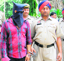 An accused in police custody in Amritsar on Sunday.