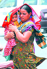 A woman protecting her child from the scorching heat in Bathinda on Sunday