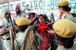 Police personnel had to resort to the use of lathis to rein in the unruly crowd as the demolition drive started in the Prajapat Colony in Bathinda on Sunday