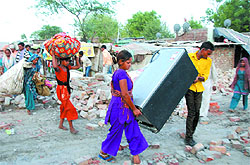 As the demolition drive started, the occupants of the houses started shifting their belongings out of their houses