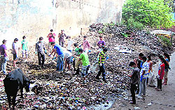 Volunteers of Making A Difference (MAD) pick garbage in Dehradun on Sunday
