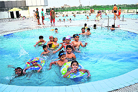 With no respite from the scorching heat, children throng a swimming pool in Rohtak